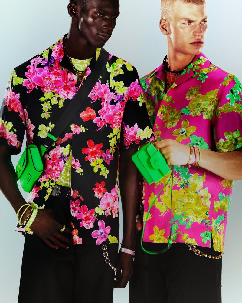 Models Momo Ndiaye and Timo Pan sport colorful prints for Versace's resort 2023 men's campaign.