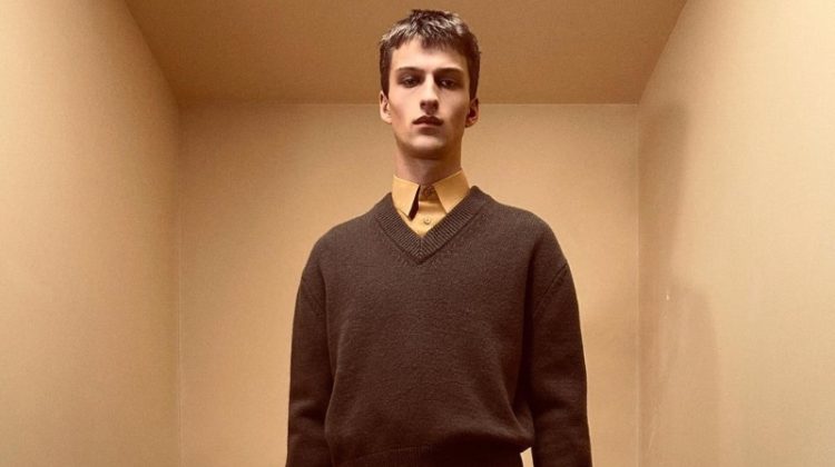 Vasko Luyckx wears a wool v-neck sweater over a shirt and shorts from the Zara Edition spring-summer 2023 collection.