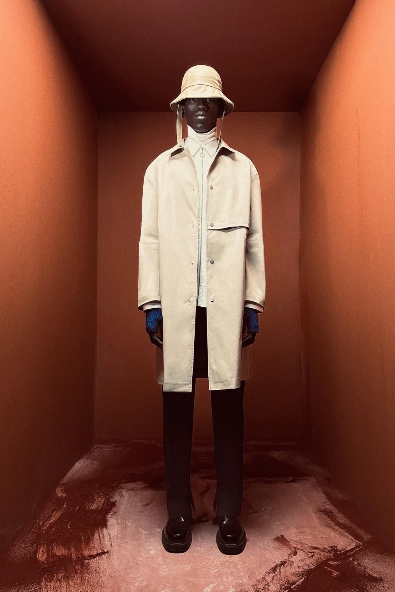 Moustapha Sy wears a trench with a zippered shirt, high-collar top, and suit pants from the Zara Edition spring-summer 2023 collection.