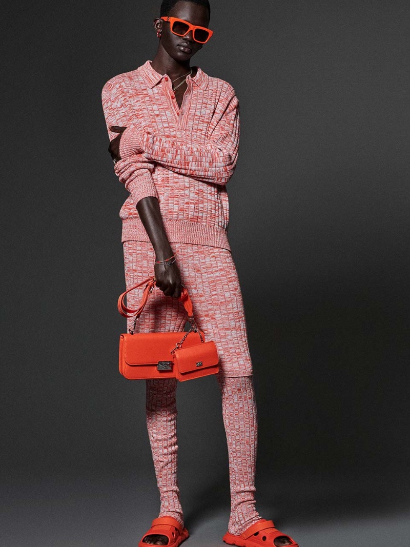 Sporting knitwear, Manyuon Deng appears in Benetton's spring-summer 2023 campaign. 