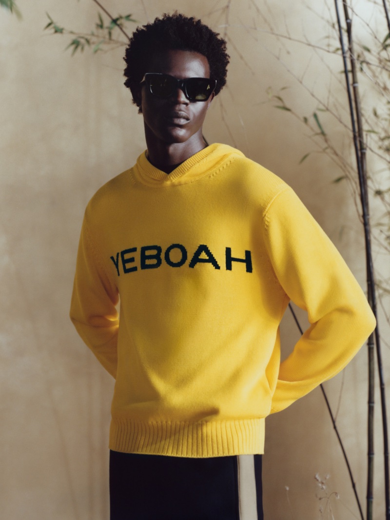 Mohammed Abubakar wears a knit hoodie from the COS x YEBOAH Metamorphosis collection.
