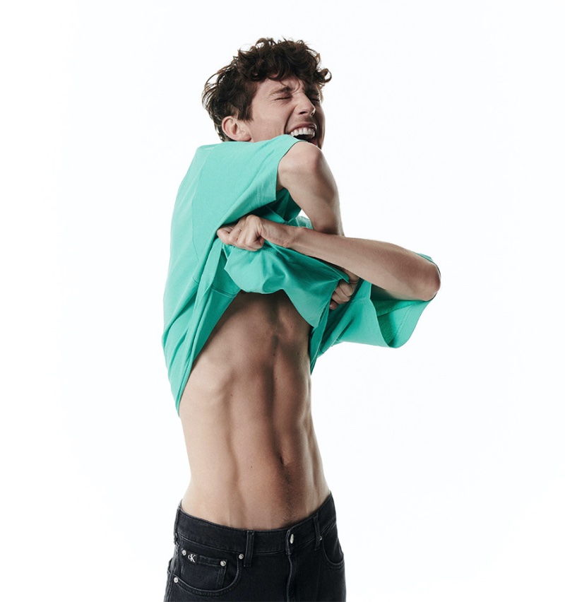 All smiles, Troye Sivan shows off his abs as he fronts Calvin Klein's Pride campaign. 