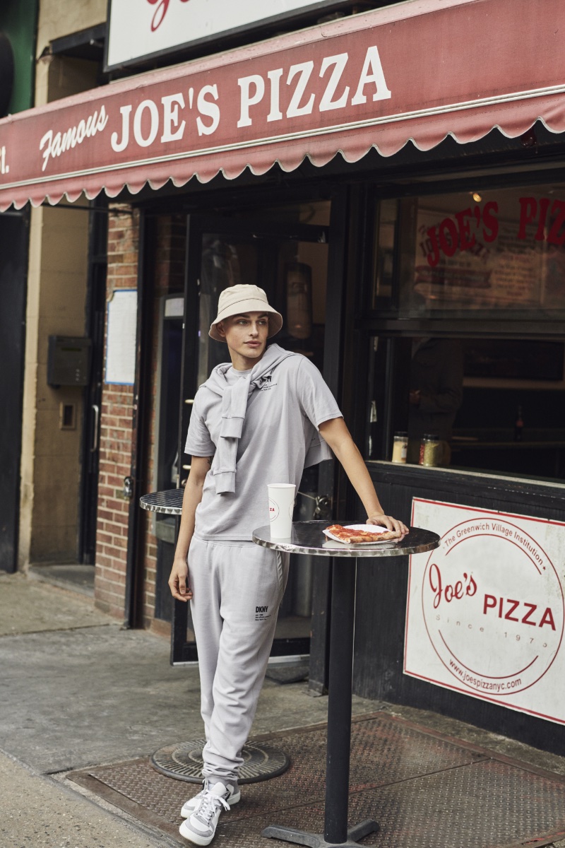 Embracing monochrome style, Cameron Porras wears a gray leisure look for DKNY's spring-summer 2023 campaign.