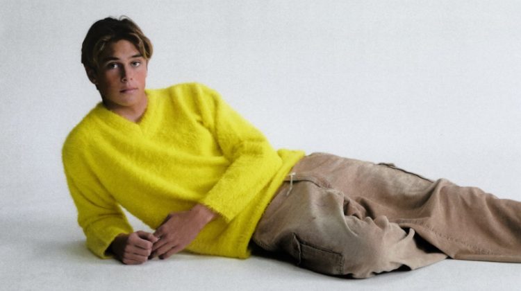 Evoking throwback style, Cole Alves rocks a lemon yellow brushed sweater by ERL.