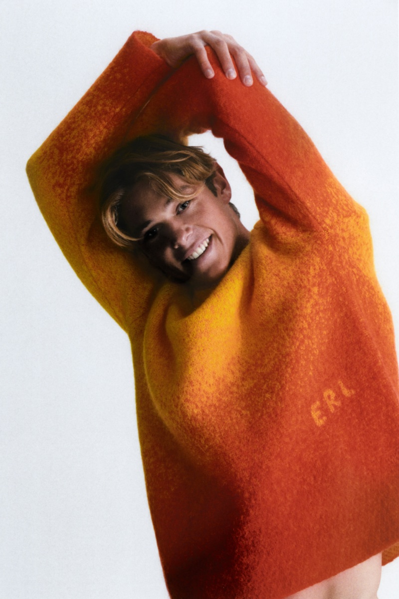 Model Cole Alves charms in an orange gradient mohair-blend sweater by ERL.