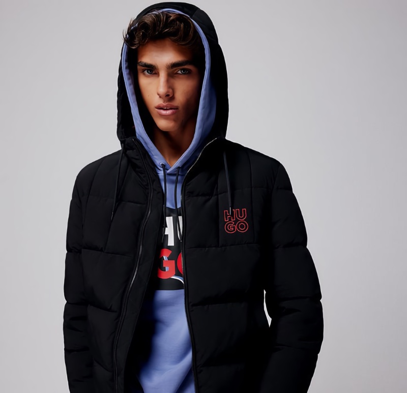Showcasing sporty style, Simone Stravolo layers in a quilted jacket and hoodie by HUGO. 