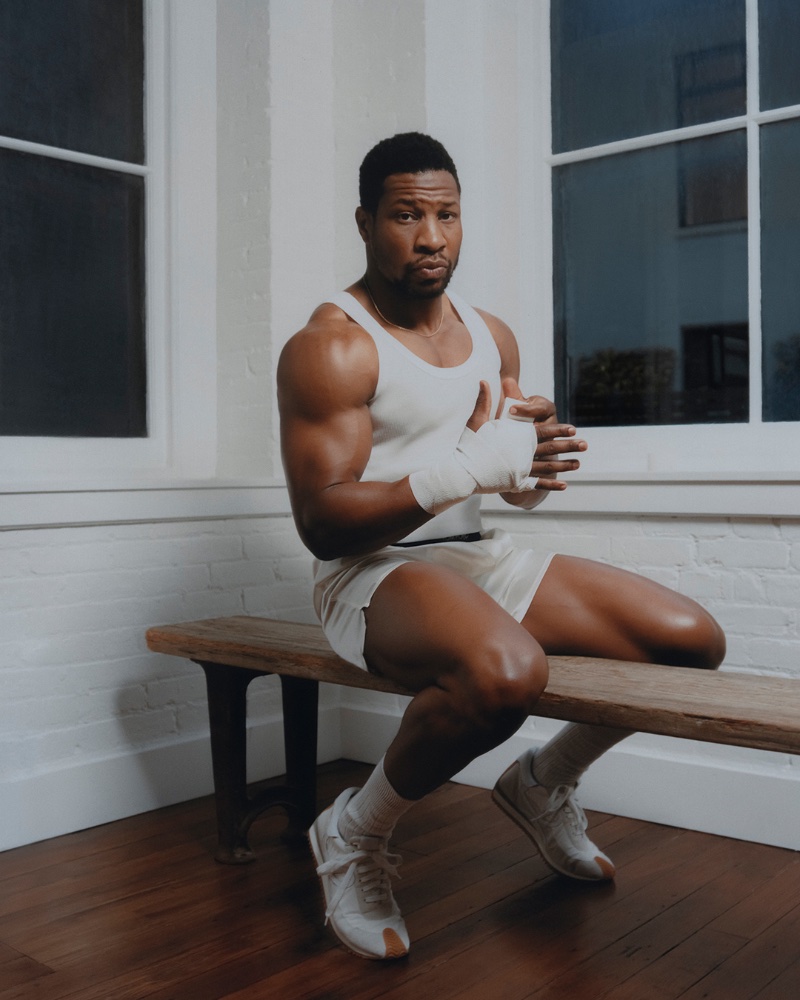 Ready to work out, Jonathan Majors sports a Schiesser tank, Tom Ford silk satin boxer shorts, Mr P. socks, and Loewe sneakers. 