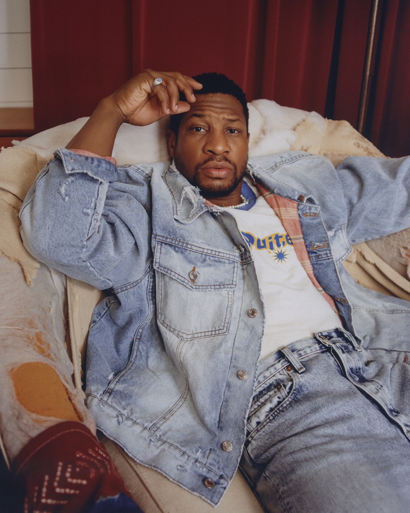 Jonathan Majors wears an Enfants Riches Déprimés denim trucker jacket with a Polite Worldwide t-shirt, OrSlow jeans, and a Hatton Labs necklace.