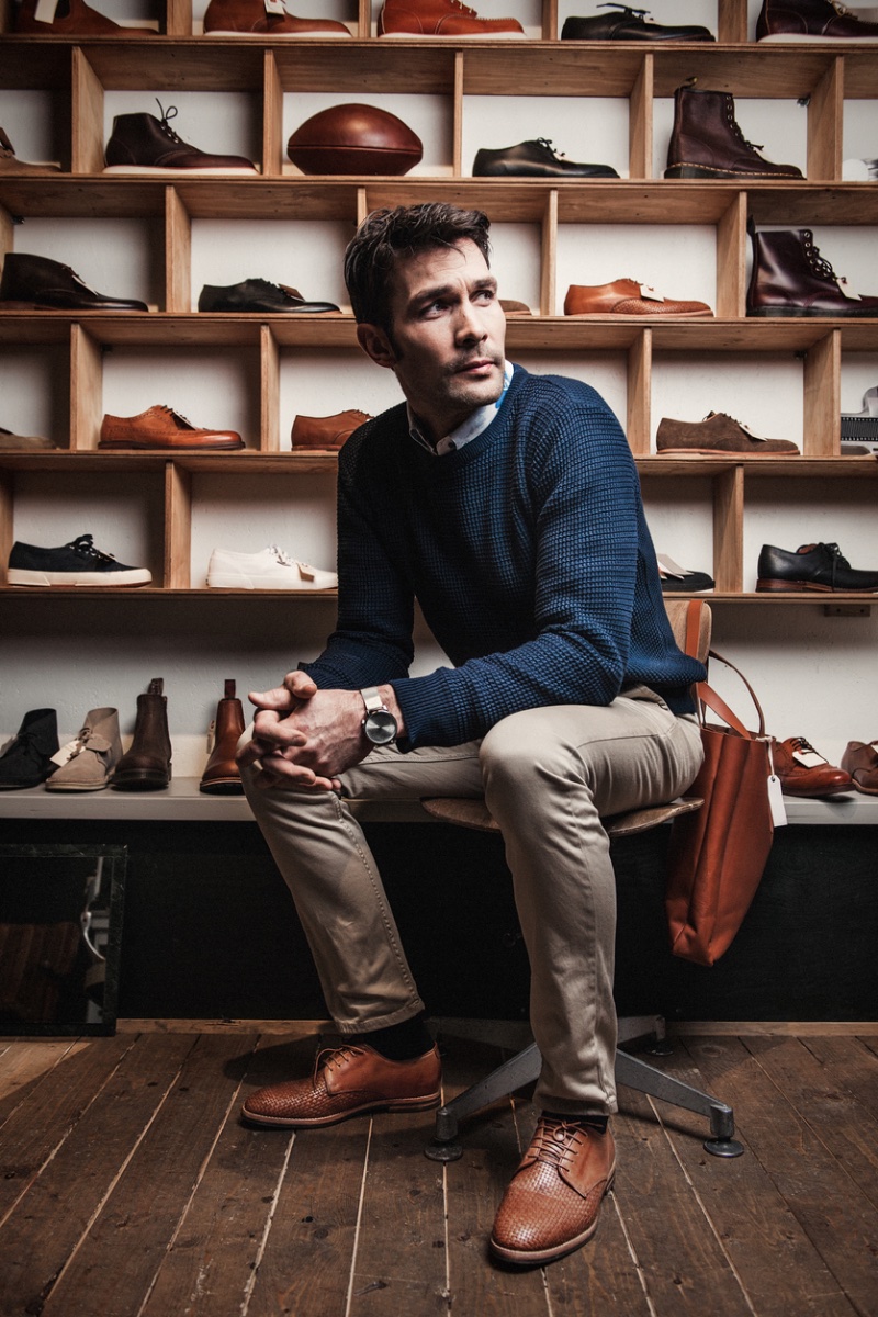 Man Surrounded by Mens Shoes