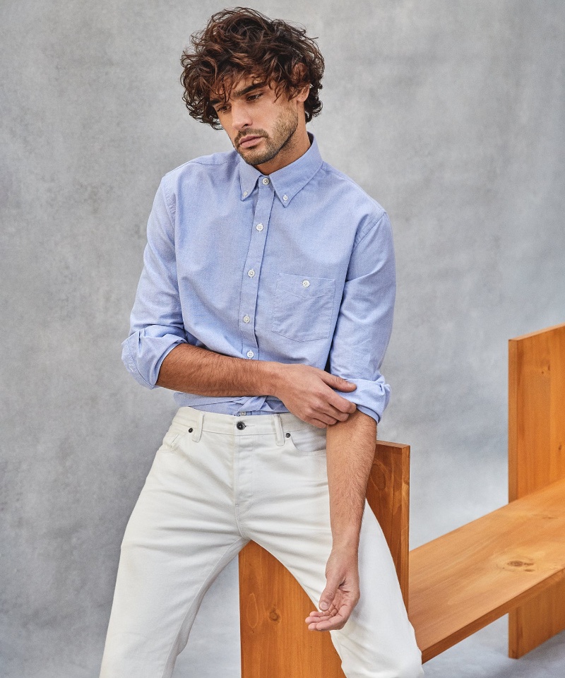 Marlon Teixeira wears a blue Todd Snyder oxford shirt with white jeans.