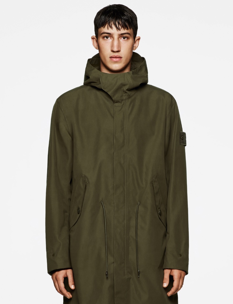 Fausto Sylvester wears a Stone Island Ghost Piece parka in military green.