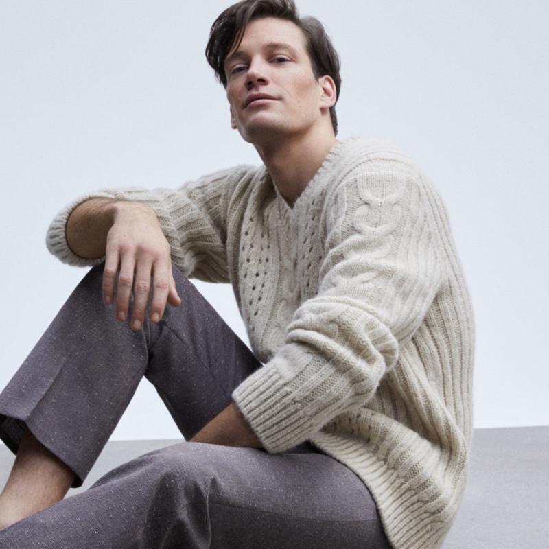 Florian Van Bael takes up the spotlight in a v-neck cable-knit sweater and trousers.