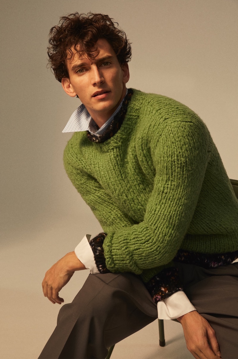 French model Thibaud Charon dons a Gabriela Hearst sweater over a Gucci striped shirt.