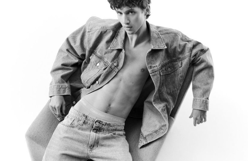 Appearing in a black-and-white photo, Troye Sivan sports a jean jacket and denim jeans for Calvin Klein's Pride campaign. 