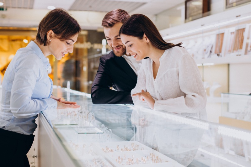 Couple Looking at Engagement Rings in Store