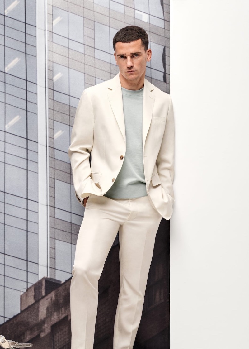 A chic vision, Antoine Griezmann dons a slim-fit linen suit for Mango's spring-summer 2023 campaign.