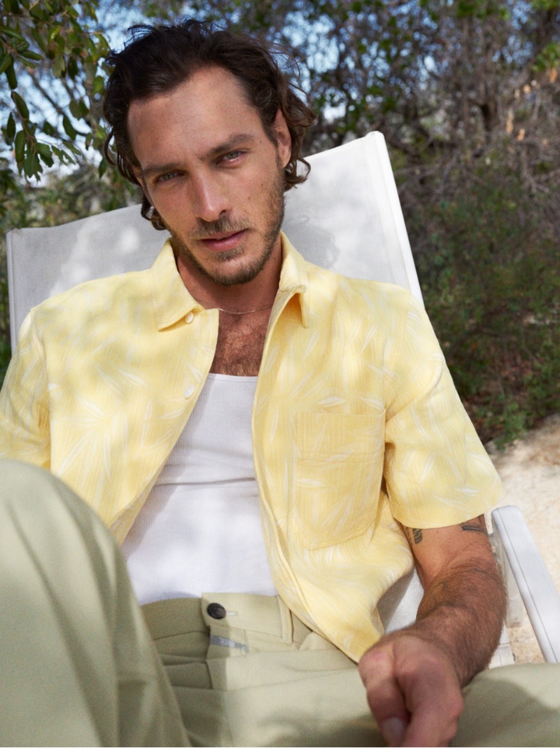 Pierre-Benoit Talbourdet sports a yellow short-sleeve shirt with slacks from Closed's summer 2023 collection.