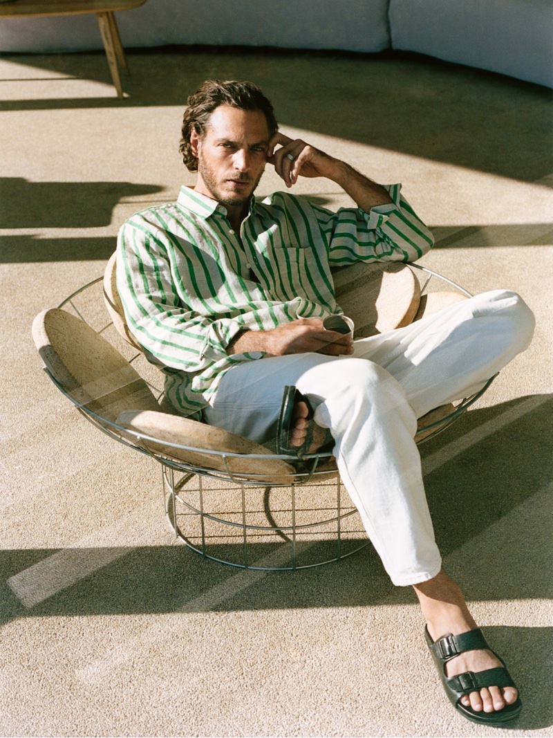Relaxing, Pierre-Benoit Talbourdet wears a striped shirt with jeans and sandals by Closed.