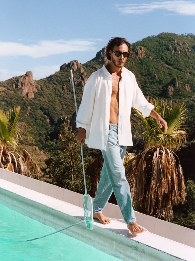 Cleaning the pool, Pierre-Benoit Talbourdet models an open white shirt with tapered jeans from Closed.