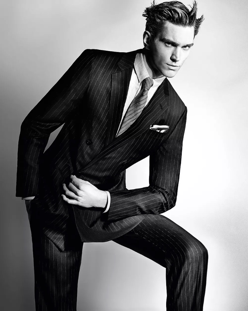 Max Lang wears a pinstripe suit from the Giorgio Armani Made to Measure spring-summer 2023 collection.