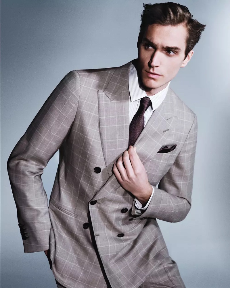 Donning a windowpane print double-breasted suit, Max Lang wears Giorgio Armani Made to Measure. 