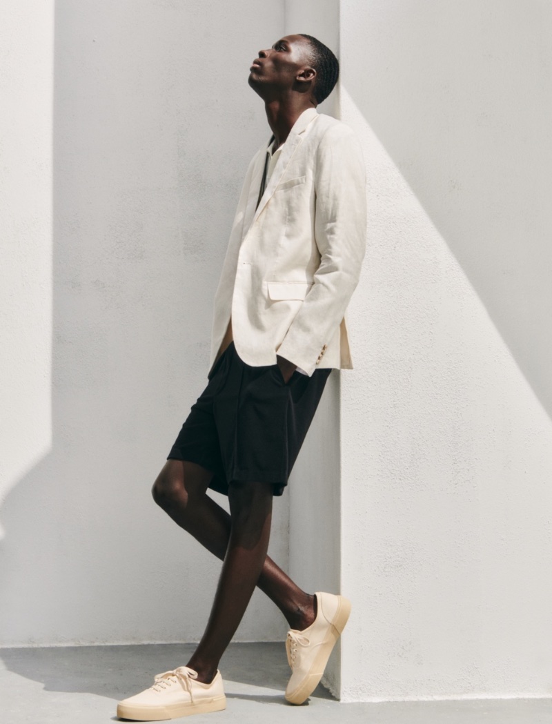 A smart vision, Khadim Sock wears a white linen blazer with terry shorts. 