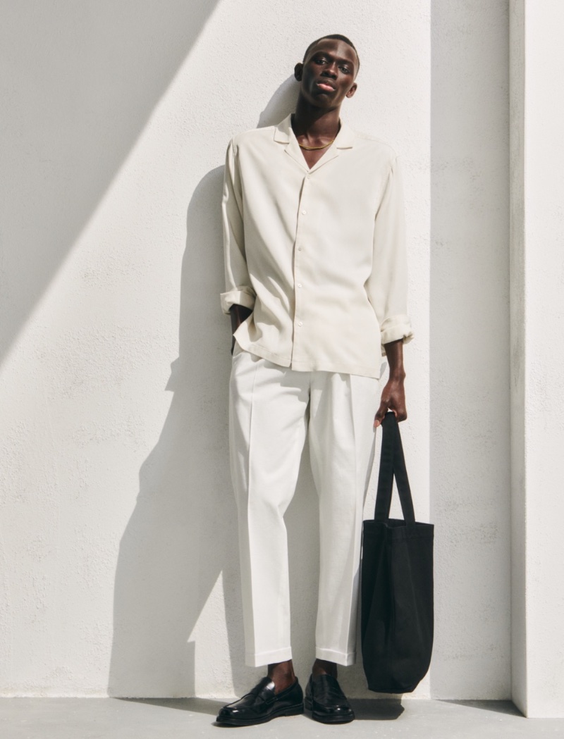 Relaxed layers are front and center as Khadim Socks dons a long-sleeve shirt with trousers.