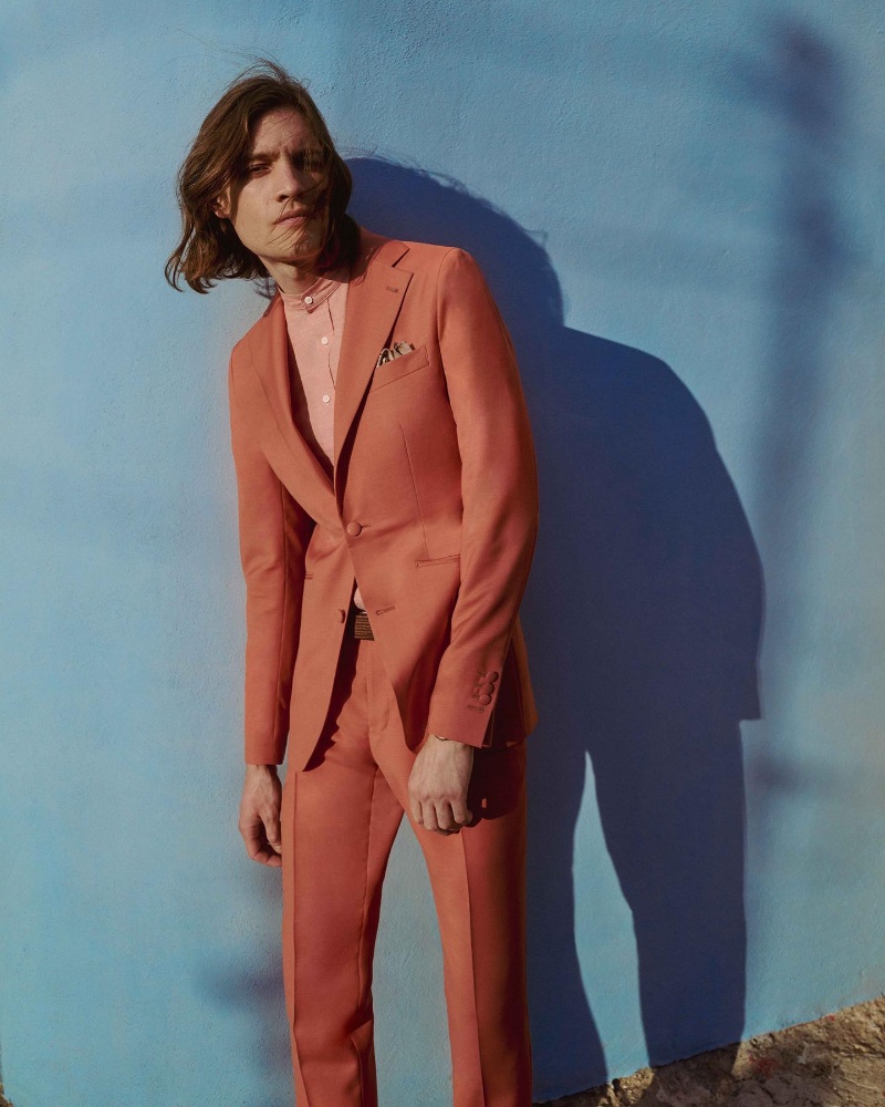 Marcel Castenmiller dons an apricot-colored suit by INDOCHINO from its spring-summer 2023 collection.