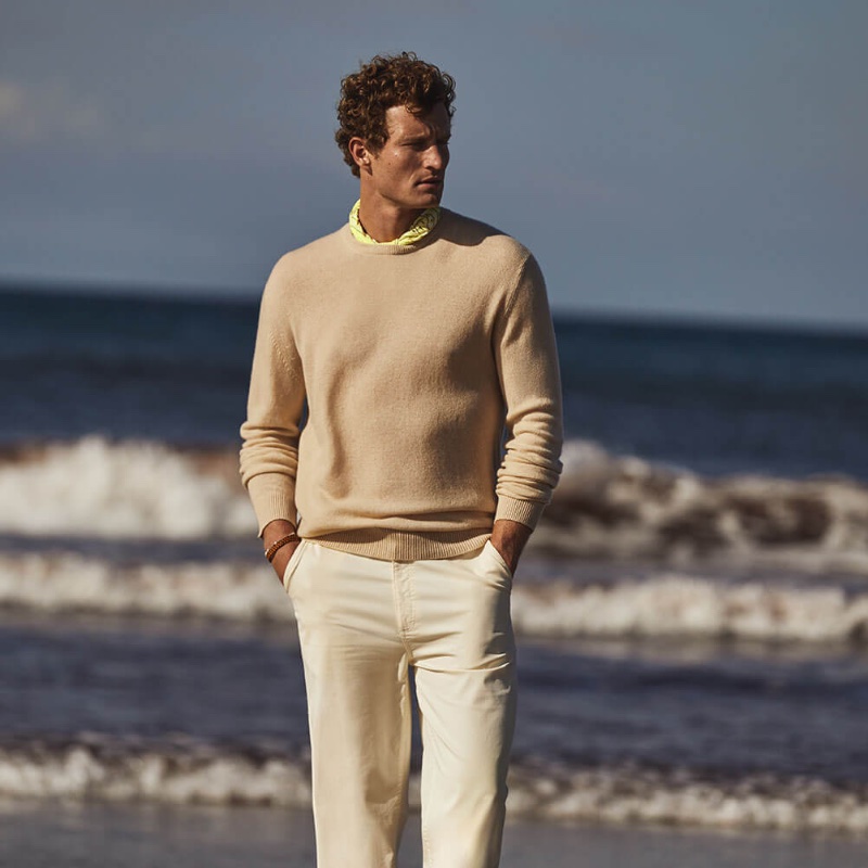 Taking to the beach, Bas Tijhof dons a Johnstons of Elgin cashmere crewneck sweater.