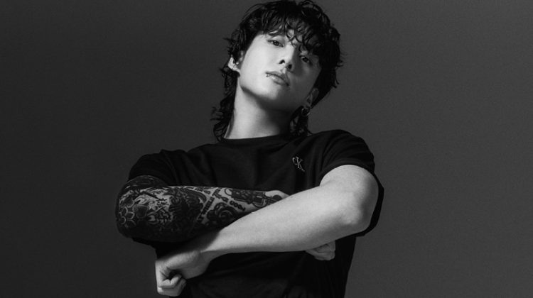 Jung Kook rocks a black Relaxed Fit Archive Logo Tee with Standard Straight Jeans for Calvin Klein's spring-summer 2023 campaign.