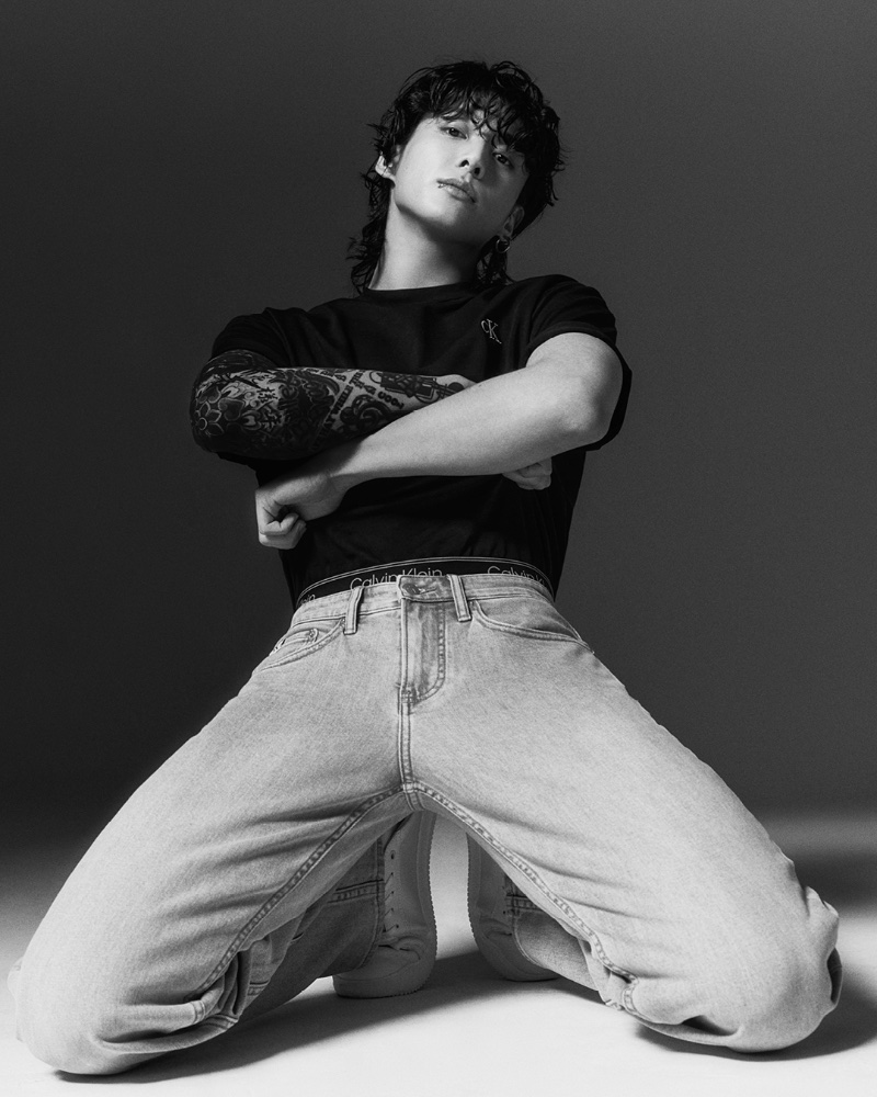 Jung Kook rocks a black Relaxed Fit Archive Logo Tee with Standard Straight Jeans for Calvin Klein's spring-summer 2023 campaign.