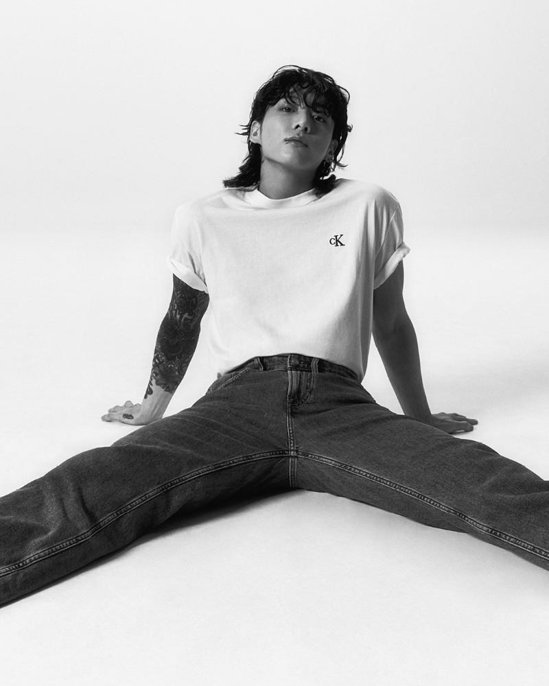 BTS member Jung Kook sports a white Relaxed Fit Archive Logo Tee with Standard Straight Jeans for Calvin Klein's spring-summer 2023 campaign.