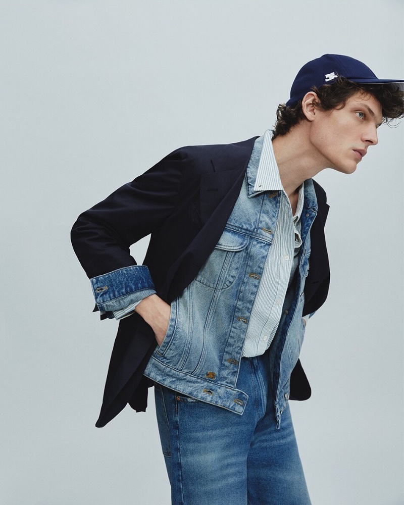Rocking classic denim, Valentin Caron wears a Courreges cap $180 and dirty blue denim jacket $800 with a Dunst seersucker shirt $142 and MM6 Maison Margiela straight jeans $475. 
