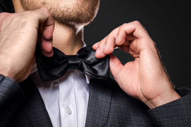 Man Adjusting Bow Tie » Formal Grooming Tips Every Man Should Know Before a Big Event Man Adjusting Bow Tie
