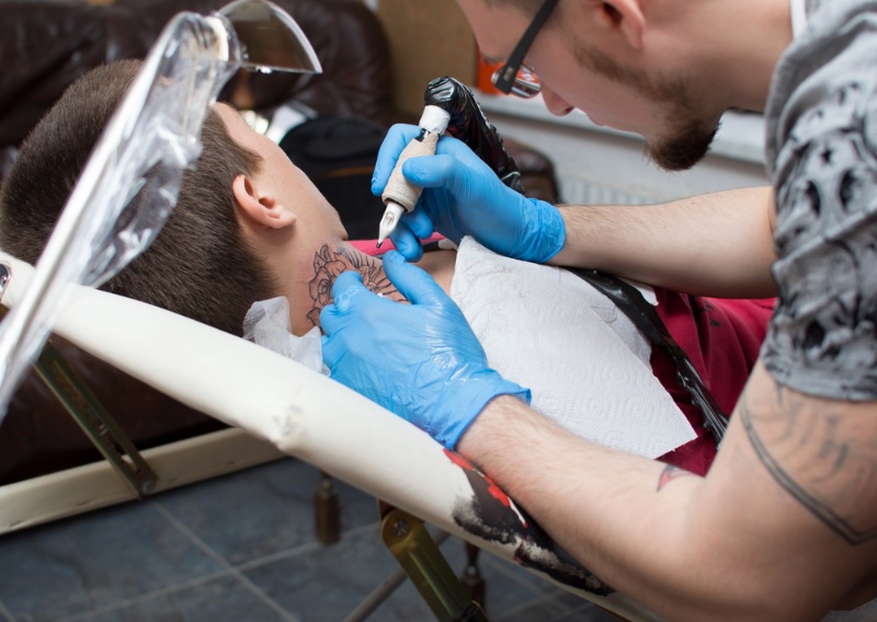 Man Getting Neck Tattoo