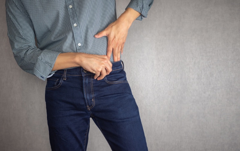 Man Tucking in Button-Down Shirt Jeans