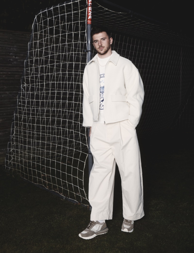Making a case for an all-white outfit, Mason Mount wears a LE17SEPTEMBRE jacket, Studio Nicholson pants, an S.S. Daley sweater, and Visvim sneakers. 