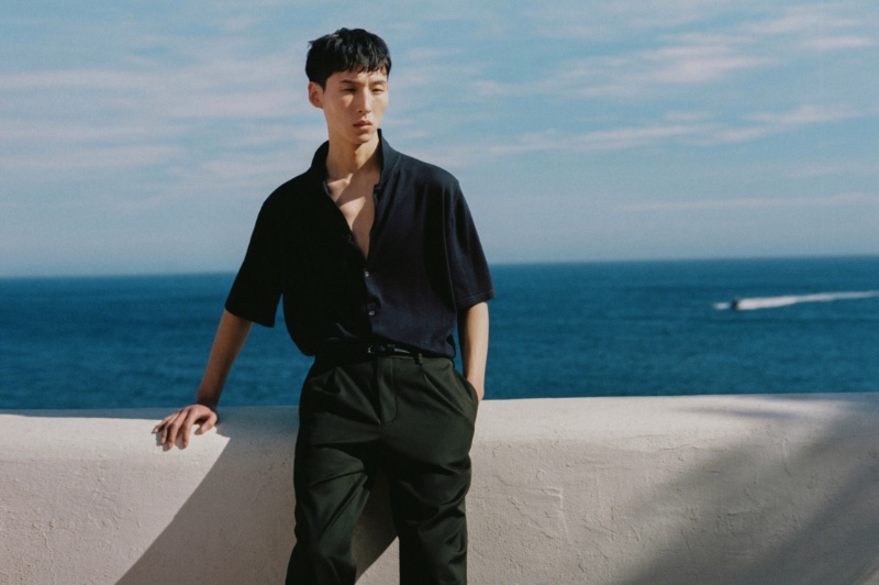 Sporting a dark summer outfit, Woosang Kim wears Massimo Dutti. 