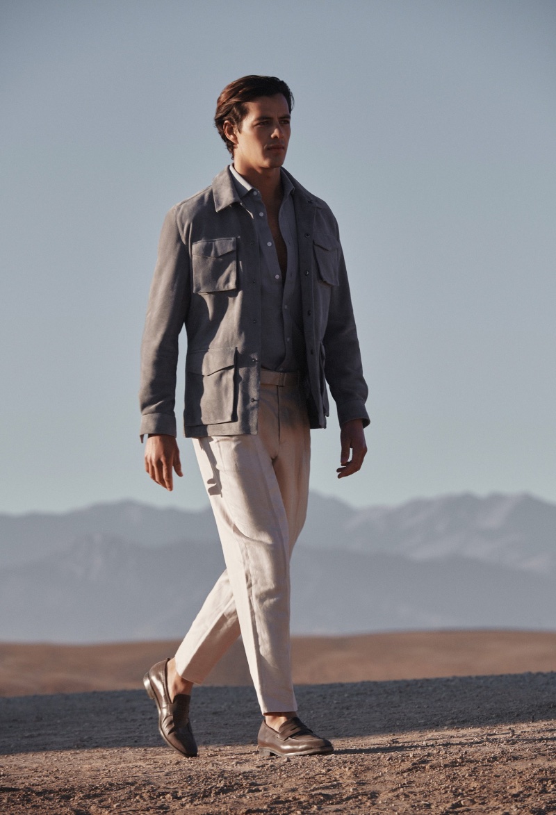 Embracing safari style, Harry Gozzett wears a suede long-sleeve four pocket jacket $825 for REISS' spring-summer 2023 campaign.