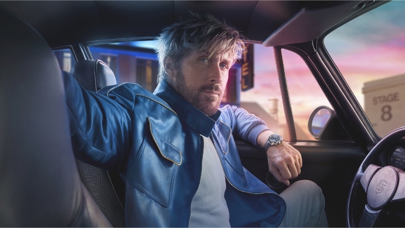 The TAG Heuer "The Chase for Carrera" campaign features Ryan Gosling donning a stylish blue leather jacket as he takes the wheel.