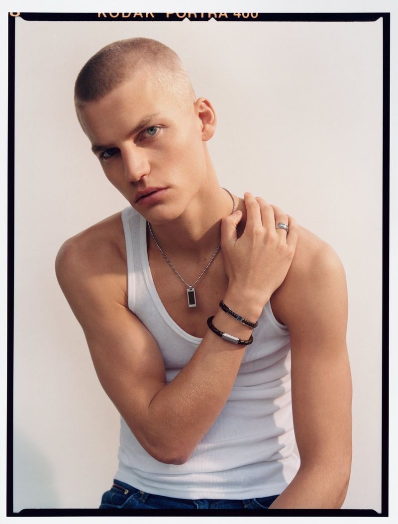 Model Timo Pan sports casual jewelry, including a ring, necklace, and bracelets for Tommy Hilfiger's spring-summer 2023 accessories campaign.