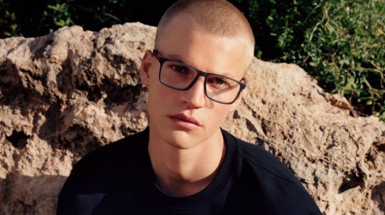 Wearing dark-framed glasses, Timo Pan fronts Tommy Hilfiger's spring-summer 2023 accessories campaign.