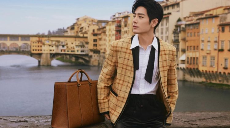 Xiao Zhan wears a Gucci check cotton-linen formal jacket as he poses alongside a GG embossed tote bag.