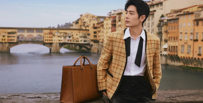Xiao Zhan wears a Gucci check cotton-linen formal jacket as he poses alongside a GG embossed tote bag.