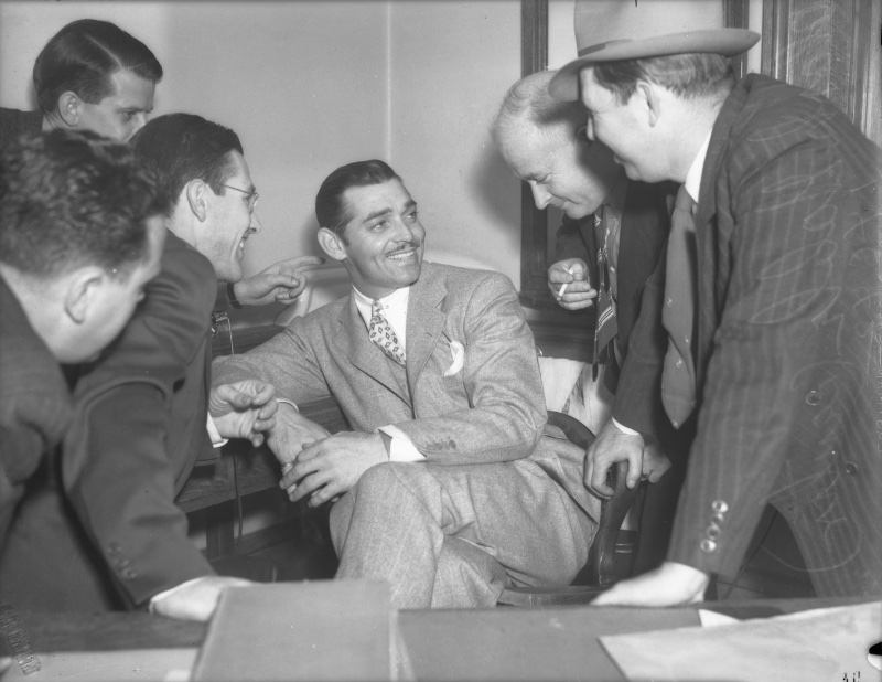 Clark Gable converses with a group of men circa 1937.
