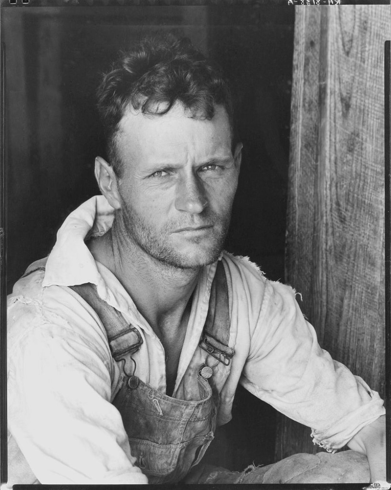 Cotton sharecropper Floyd Burroughs of Hale County, Alabama, wears overalls with a button-down shirt circa 1935-36.