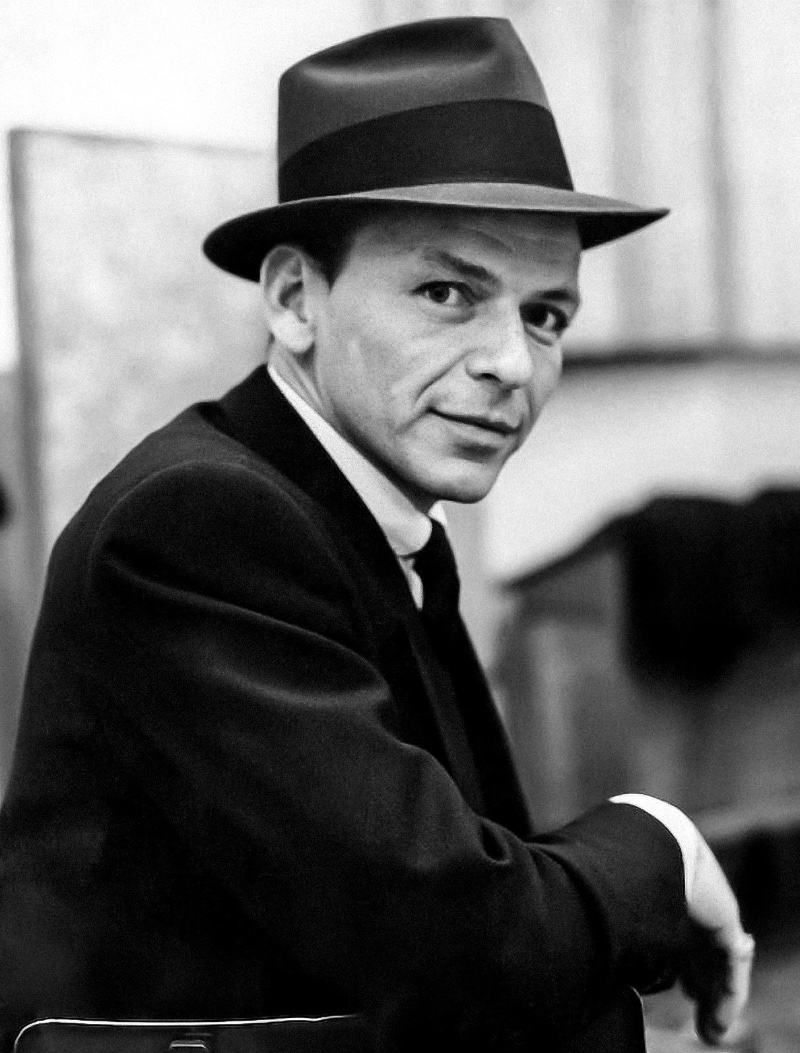 Frank Sinatra wears his signature fedora in a 1957 studio portrait. 