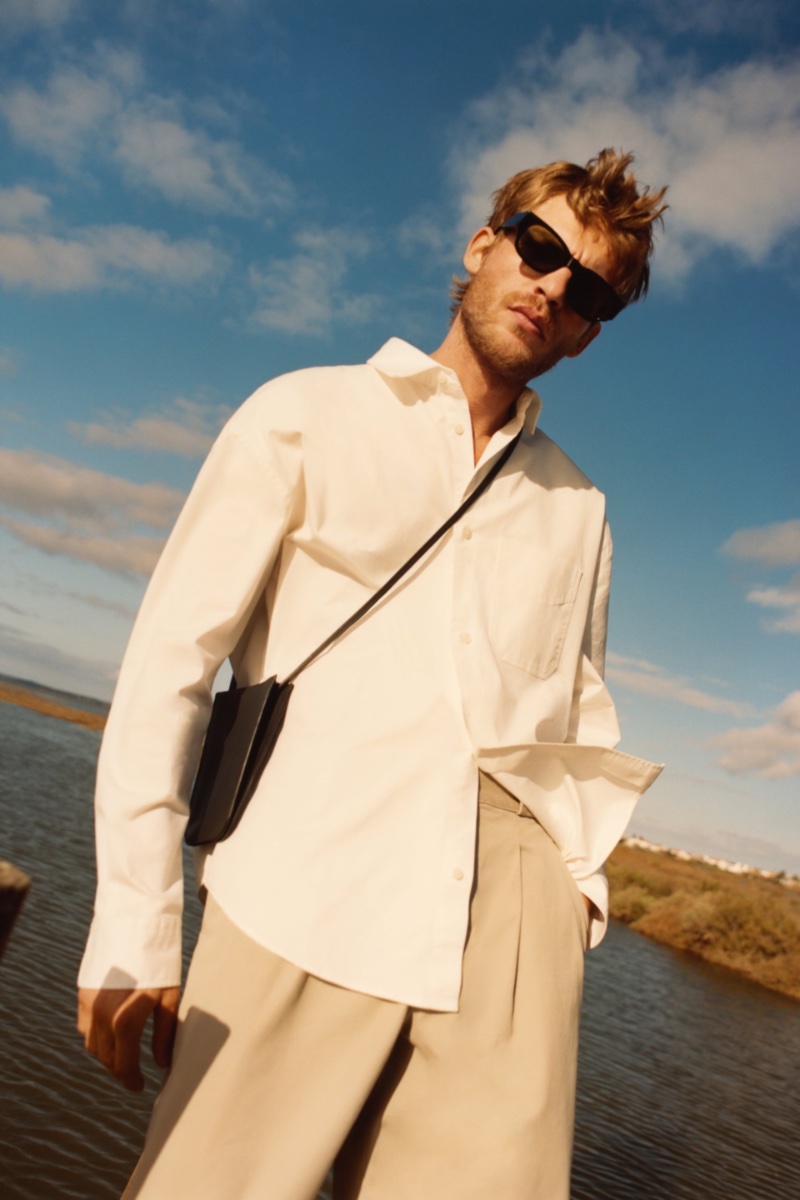Connecting with Zara, Baptiste Radufe models a twill cotton pocket shirt with wide-leg pleated pants.