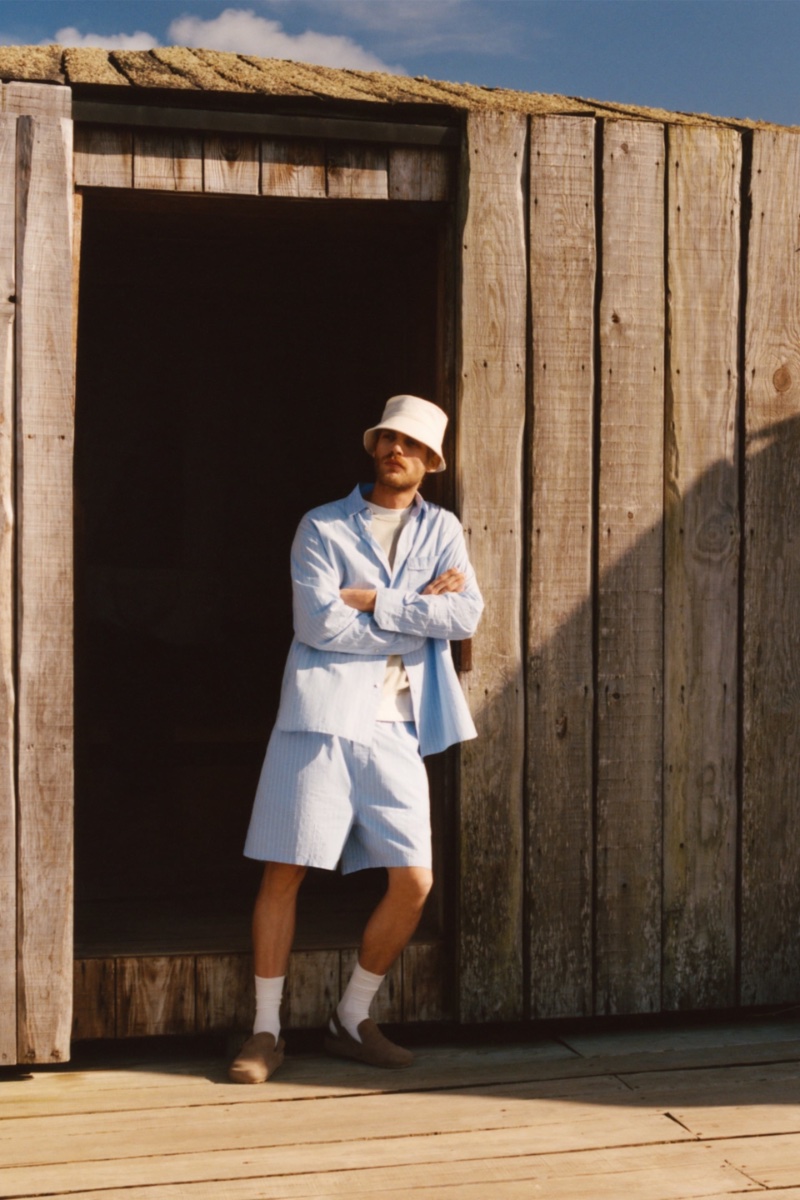 Rocking a trendy bucket hat, Baptiste Radufe also wears a striped shirt and shorts CO-ORD set. 