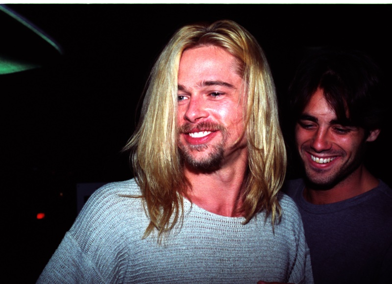 Brad Pitt displays his long bleached blond hair as he exits Roxbury nightclub in 1994.